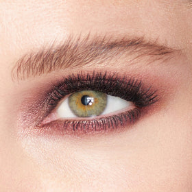 Charlotte Tilbury shadow applied on eyelid demonstrating luminous bronze payoff and crease-resistant wear