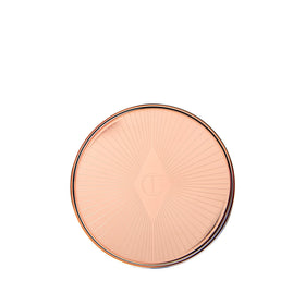Charlotte Tilbury cheek application with fingertip for natural glow