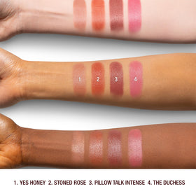 Charlotte Tilbury swatch on arm displaying deep berry-rose shade and buildable coverage