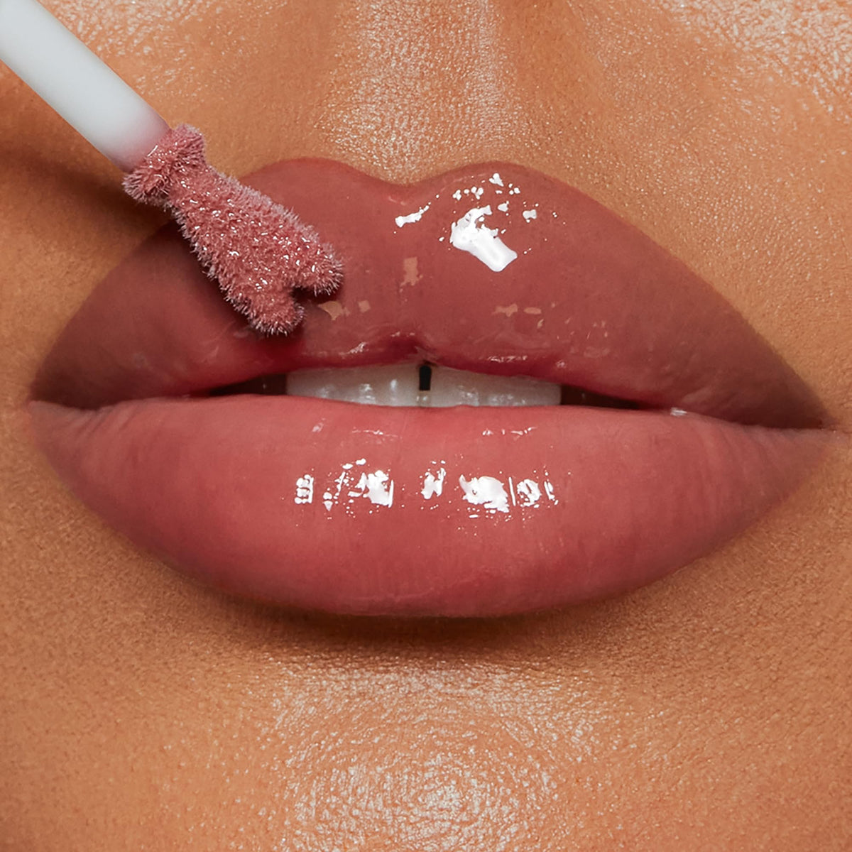 Charlotte Tilbury Pillow Talk Medium swatch on arm revealing warm berry-pink benefit