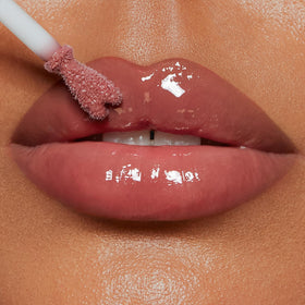 Charlotte Tilbury Pillow Talk Medium swatch on arm revealing warm berry-pink benefit