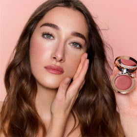 Charlotte Tilbury product size comparison with hand for scale