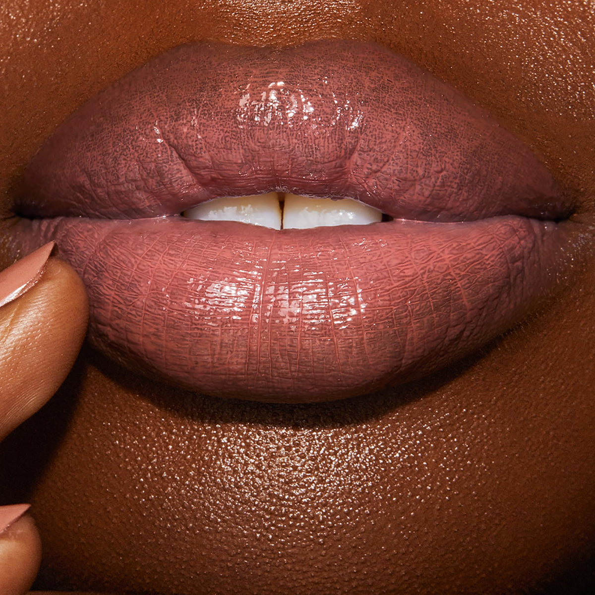 Charlotte Tilbury Pillow Talk swatch on arm showing true nude-pink shade and buildable color