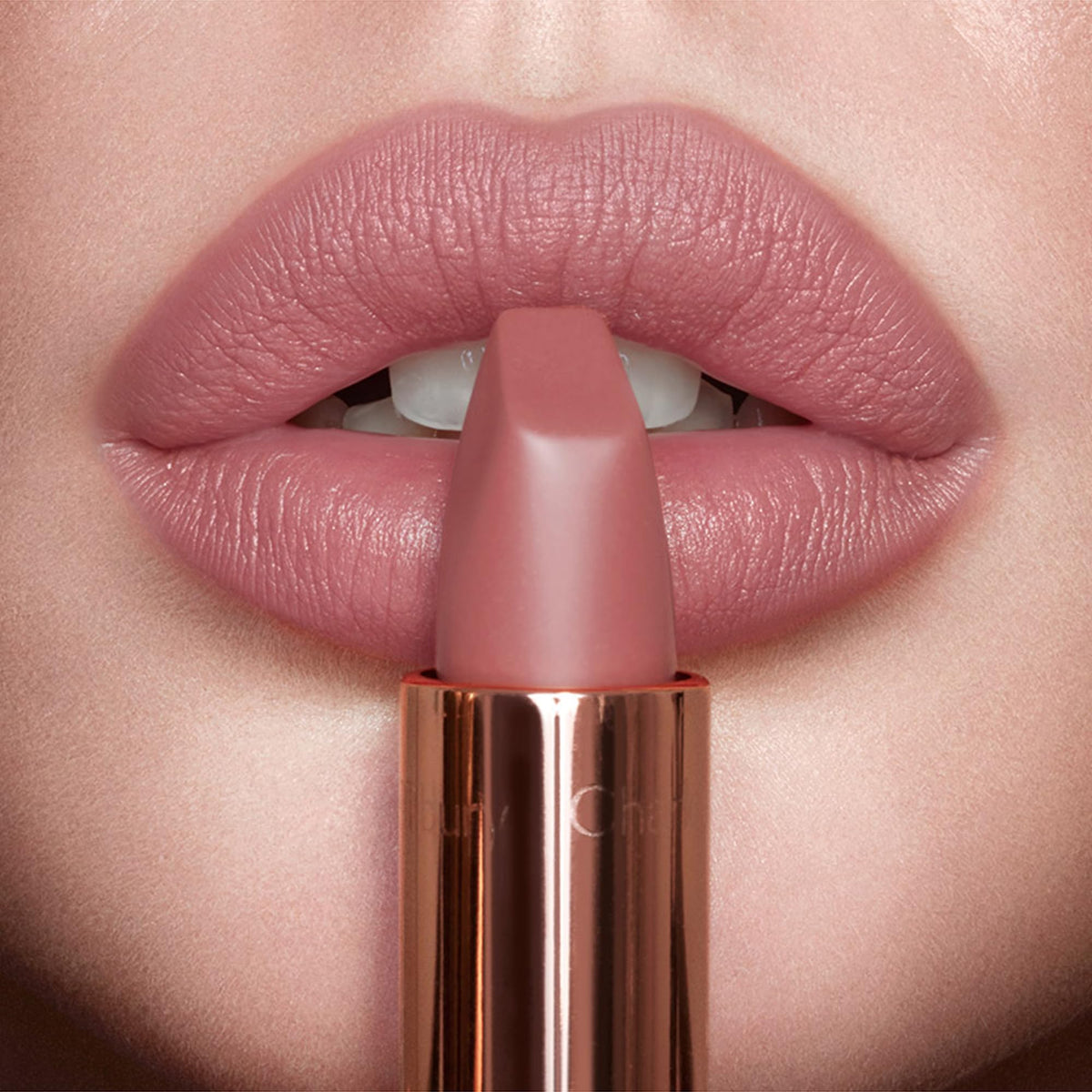 Charlotte Tilbury lipstick in hand to show scale and easy everyday use benefit