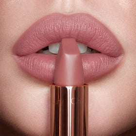 Charlotte Tilbury lipstick in hand to show scale and easy everyday use benefit