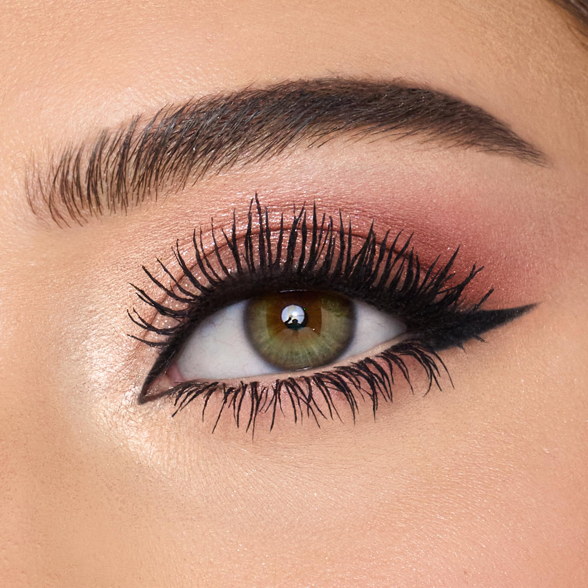 Charlotte Tilbury red-brown swatch on arm showing depth for crease definition benefit