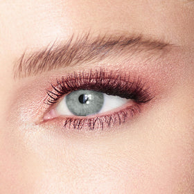 Charlotte Tilbury Rose Gold on fingertip demonstrating easy application and concentrated shimmer payoff