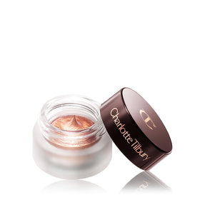 Charlotte Tilbury pot size comparison beside fingers illustrating compact, portable single eyeshadow