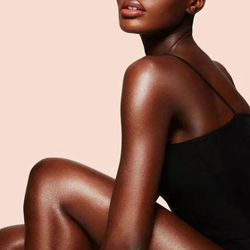 Charlotte Tilbury applied on leg in lifestyle scene, demonstrating sculpted glossy glow benefit