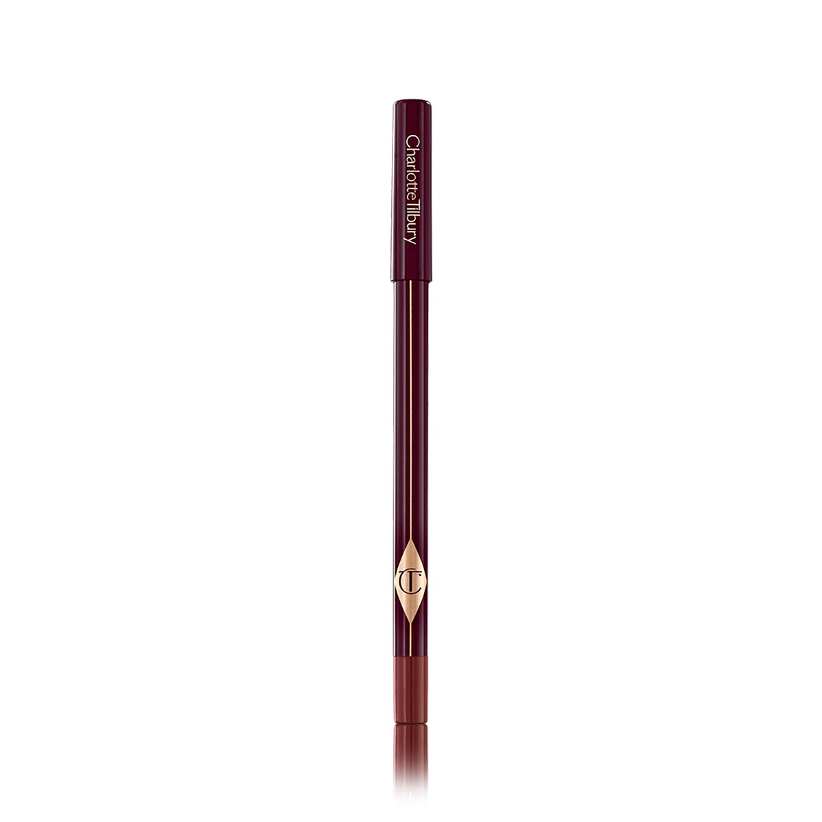 Charlotte Tilbury pencil next to a hand for scale showing compact, travel-friendly size