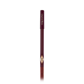 Charlotte Tilbury pencil next to a hand for scale showing compact, travel-friendly size