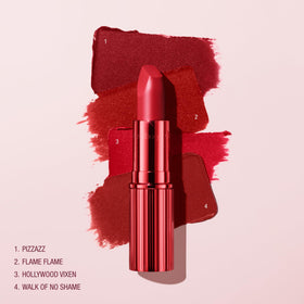 Charlotte Tilbury lipstick beside coin to show size and portability