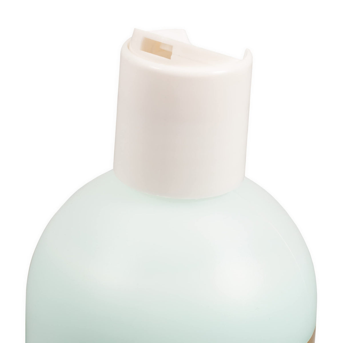 Chris Christensen bottle held in hand showing 16 oz scale and travel-friendly benefit