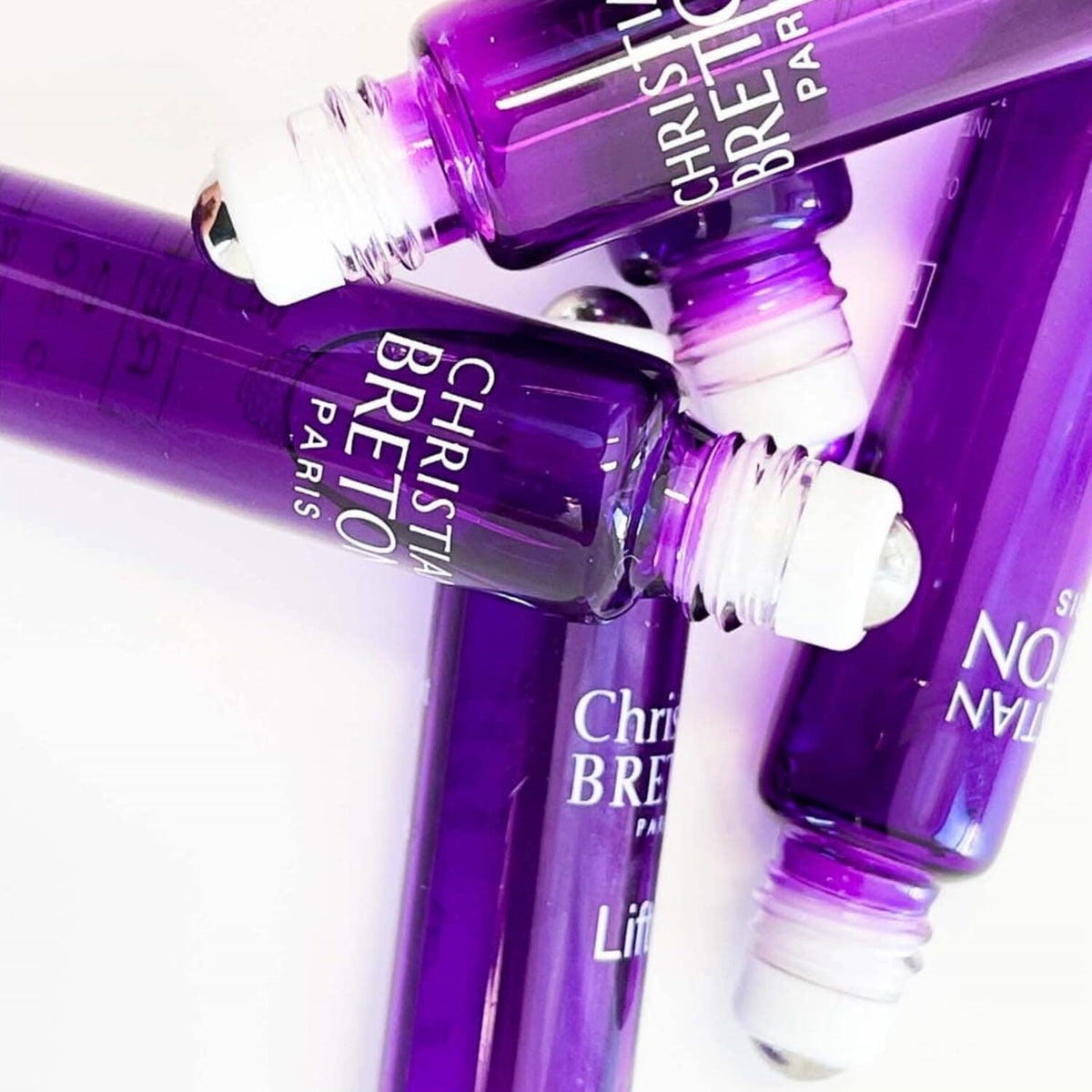 Christian BRETON roll-on application under eye demonstrating targeted cooling benefit