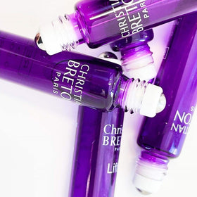 Christian BRETON roll-on application under eye demonstrating targeted cooling benefit
