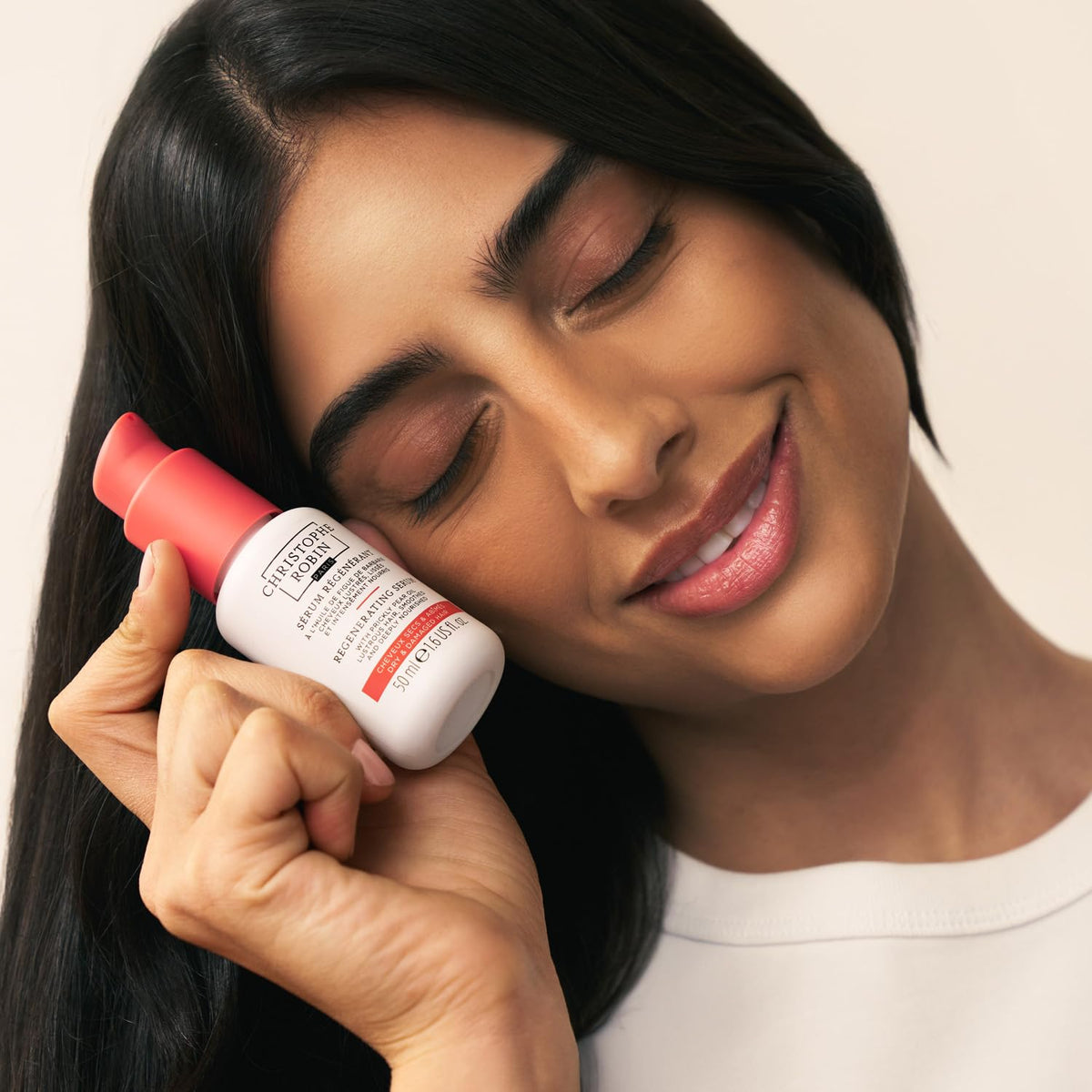 Christophe Robin application: small amount of serum in hand ready to nourish and smooth hair
