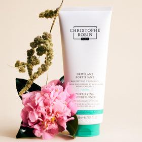 Christophe Robin conditioner on bathroom shelf, evokes salon-quality at-home routine