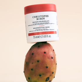 Christophe Robin 75ml travel mask beside toiletries for convenient travel care