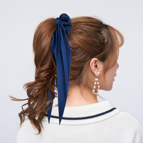 Cinaci ribbon tail detail tied in a bow, adding polished decorative flair