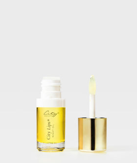 City Beauty City Lips held in hand for size comparison and easy use