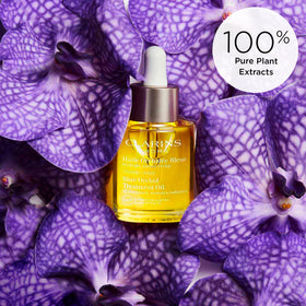 CLARINS application on hands demonstrating how oil absorbs and softens skin benefit