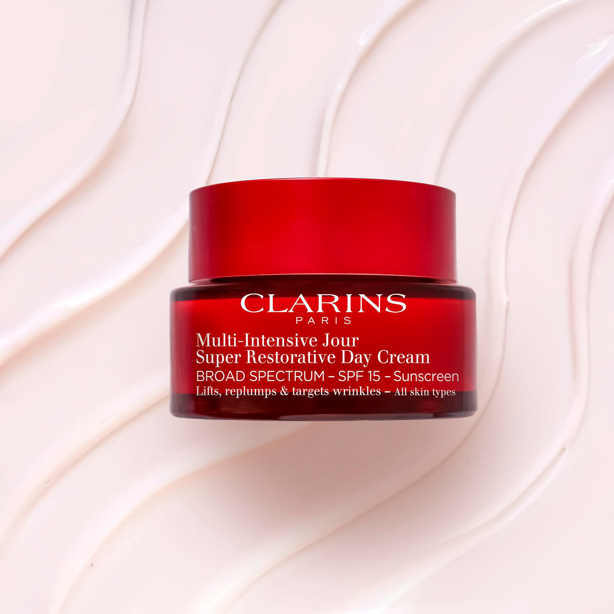 Clarins cream being applied from fingertip demonstrating easy spread and nourishing benefit