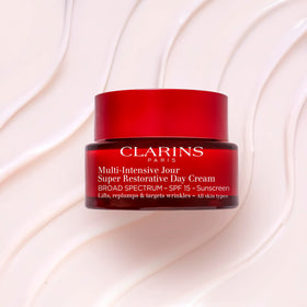 Clarins cream being applied from fingertip demonstrating easy spread and nourishing benefit