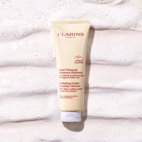 Clarins cleanser being applied to face and neck promoting gentle cleansing