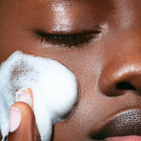 Clarins cleansing mousse in hand demonstrating convenient application and lather