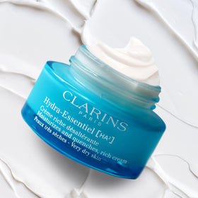 Clarins 1.7 oz cream with hand for scale showing daily size benefit