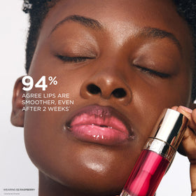 Clarins lip comfort oil layered over lipstick adding luminous shine and protective hydration