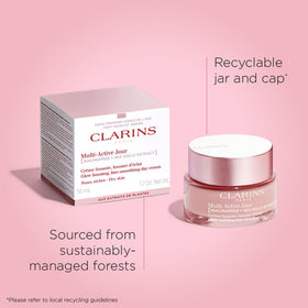 CLARINS jar held in hand to show 1.7 oz scale and travel-friendly benefit