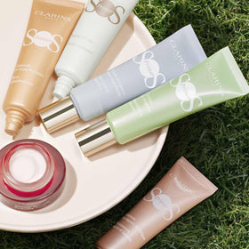 Clarins primer on vanity shelf in lifestyle scene suggesting daily use