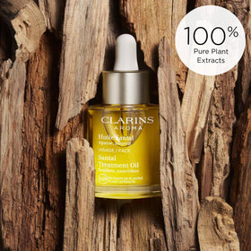 CLARINS applying Santal Face Oil to cheek illustrating soothing and softening effect