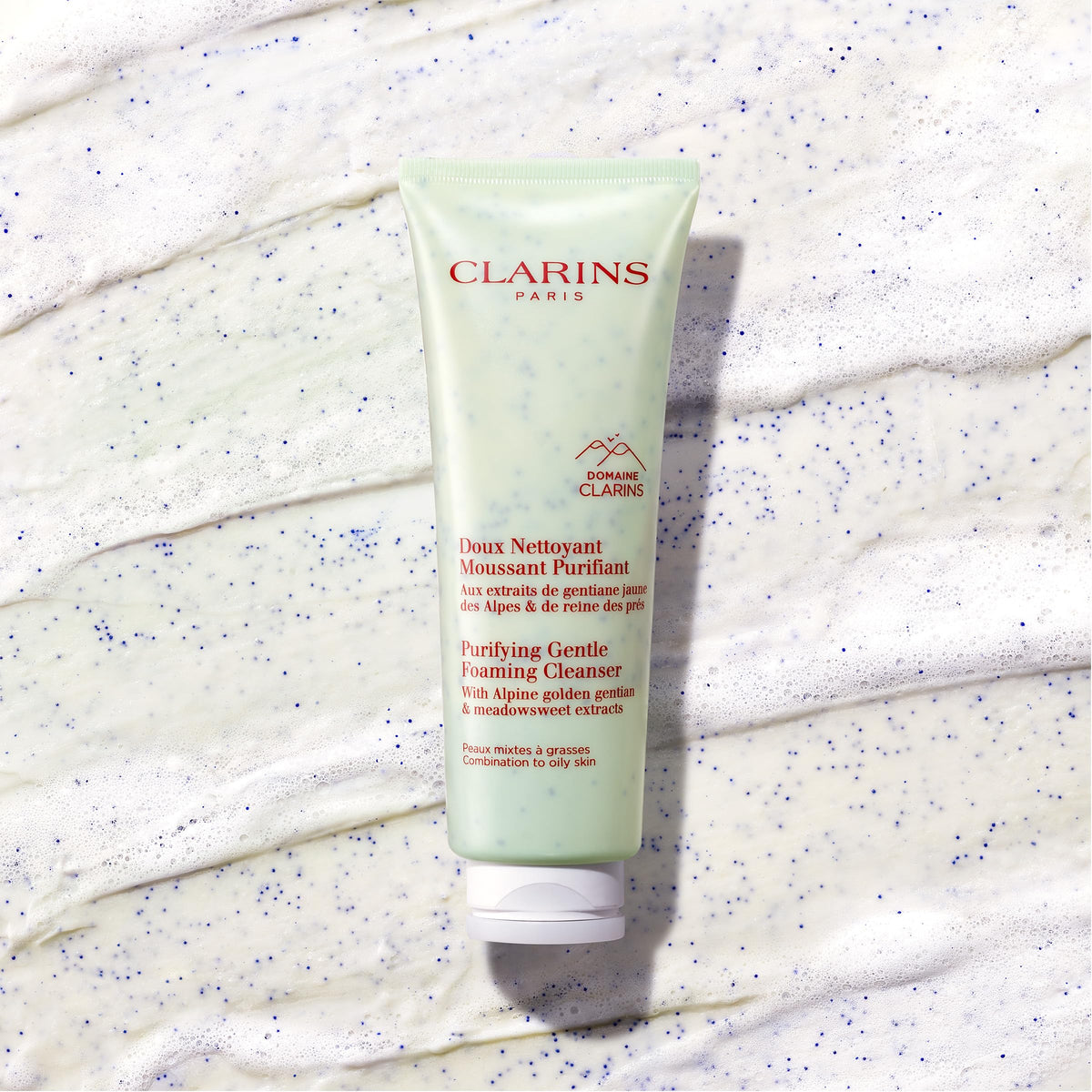 Clarins model applying cleanser demonstrating gentle facial massage