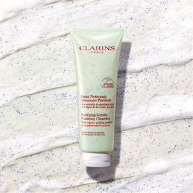 Clarins model applying cleanser demonstrating gentle facial massage