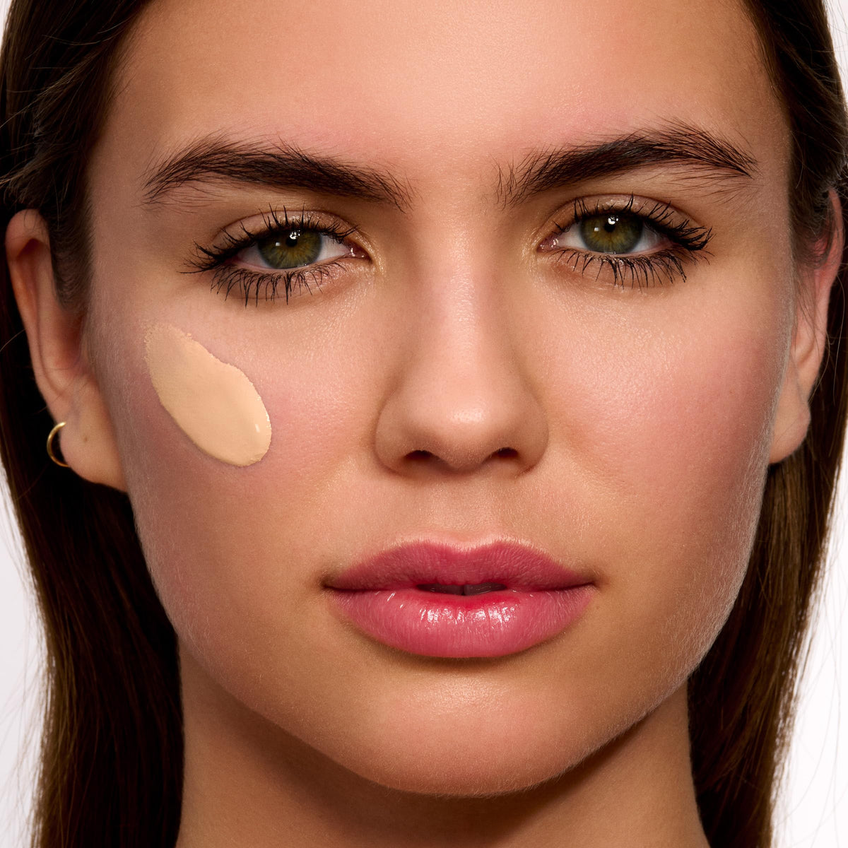 Clarins tinted swatch on hand illustrating sheer coverage and blendability