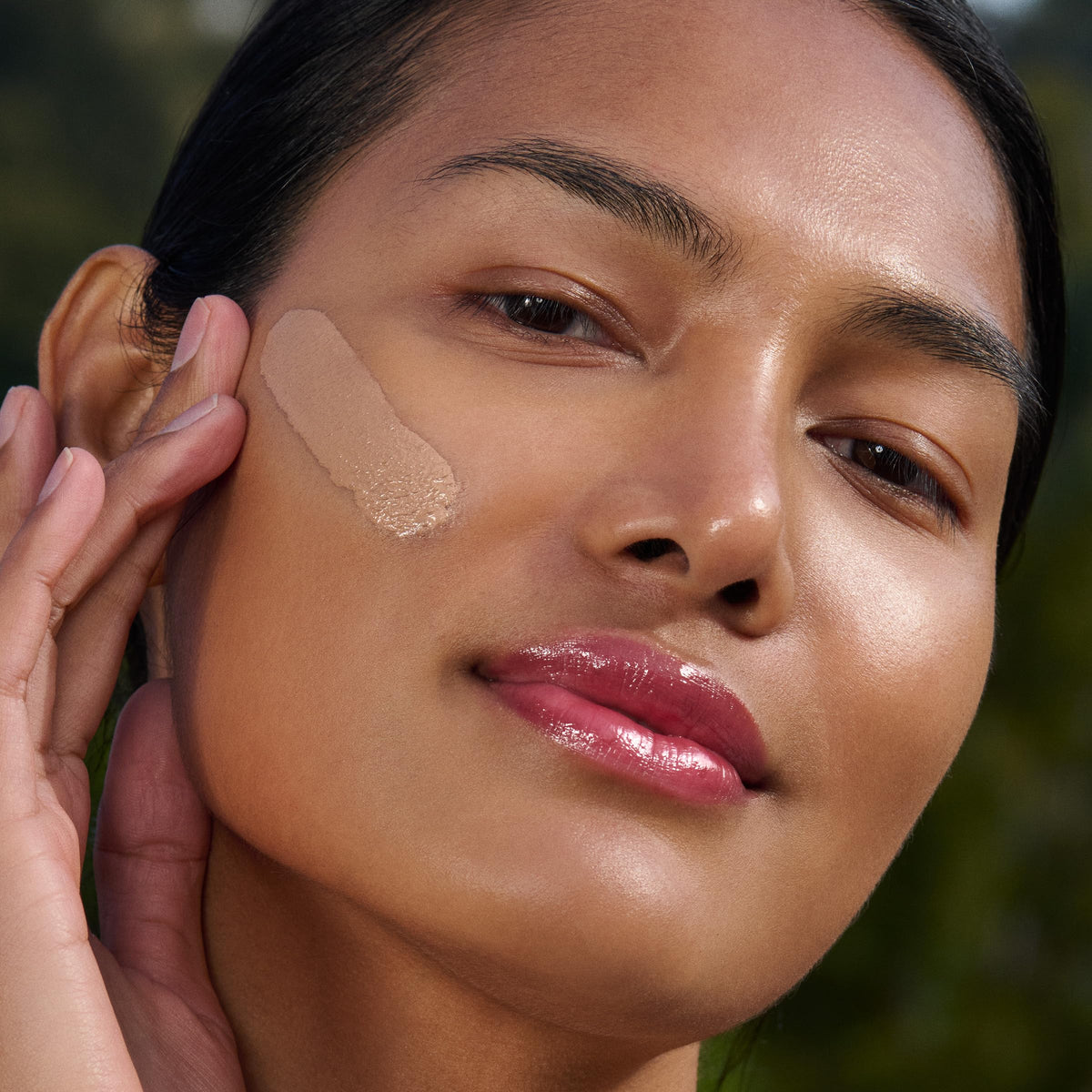 Clarins UV Plus applied on hand showing natural tint and lightweight coverage