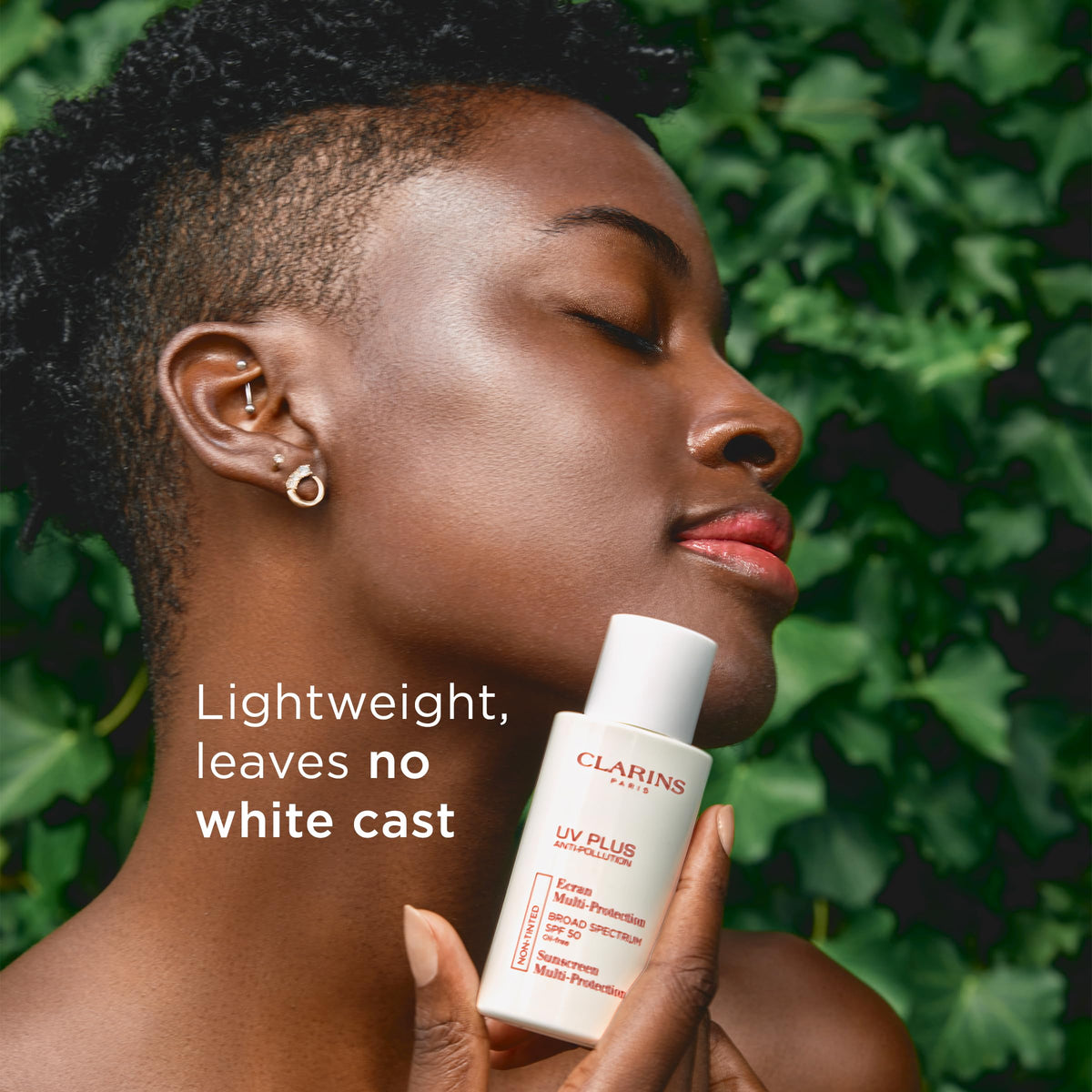 Clarins bottle next to moisturizer in flatlay showing layering in morning routine