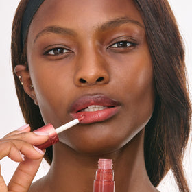Clarins Water Lip Stain paired with lip oil to show layering option for extra shine benefit