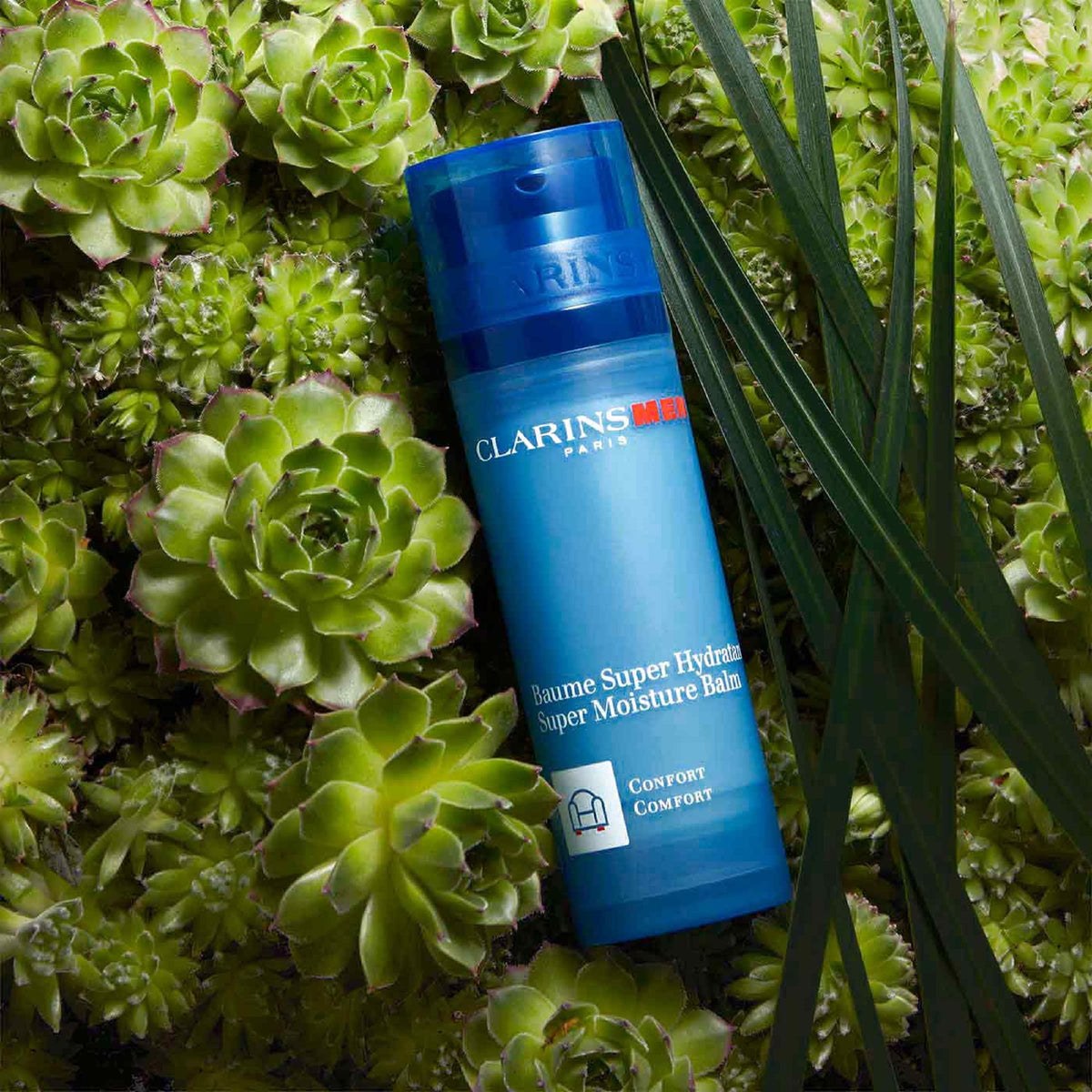 CLARINS balm next to ruler showing 1.6 ounce scale and travel-friendly size
