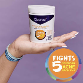 Person using Clearasil pad at mirror demonstrating convenient routine