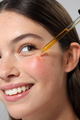 Cliganic oil being applied to hand demonstrating moisturization benefit