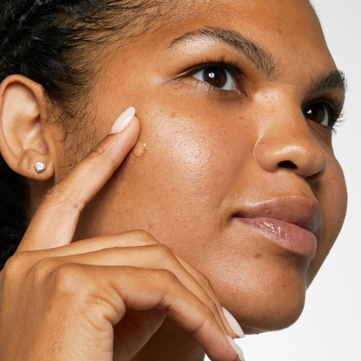 Clinique gel applied to cheek spot for targeted blemish treatment