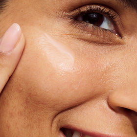 Clinique applying serum to cheek, showing gentle soothed skin benefit