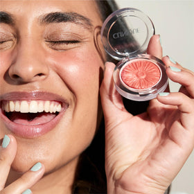 Clinique brush sweeping Heather Pop on cheeks showing easy buildable color benefit