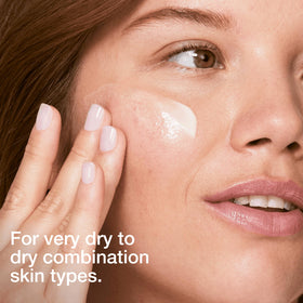 Hand applying Clinique lotion to skin demonstrating smooth spreadability and hydration benefit
