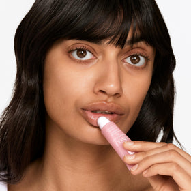 Clinique applied on lips in lifestyle shot for smooth, dewy finish