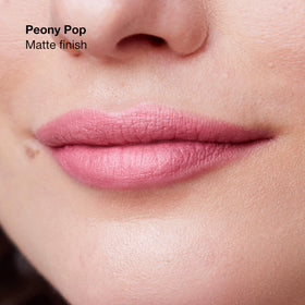 Clinique Peony Pop swatched on lips, demonstrates true-to-tint color and medium satin finish