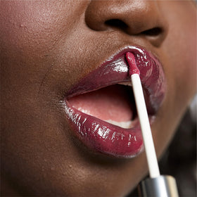 Clinique lip swatch worn Strawberry Pop showing plump, high-shine benefit